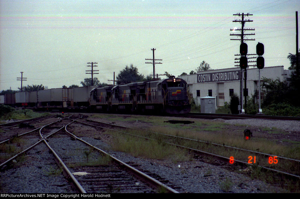 SBD 5868 leads two other B36-7's and a TOFC train past the signals at the north end of the yard